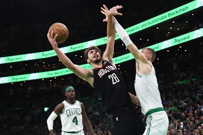 Houston Rockets center Alperen Sengun finishes over Boston Celtics center Kristaps Porzingis
